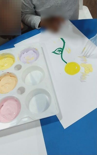 A child painting a bright picture during creative play